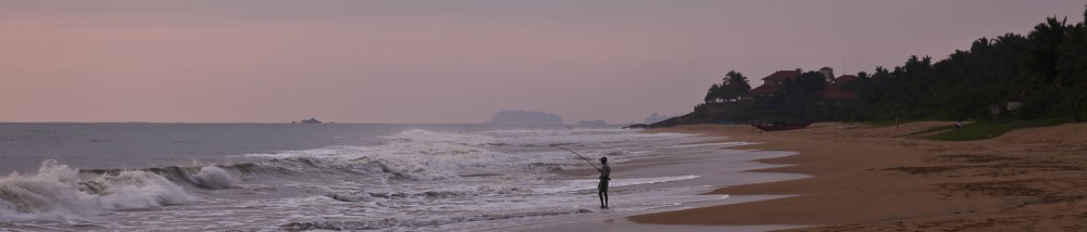 Fisherman at sunset on the beach at the Temple Tree Resort and S